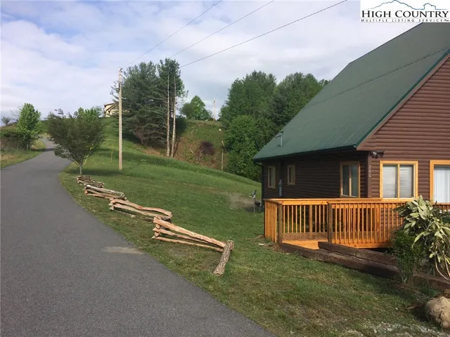 a view of a house with backyard and porch