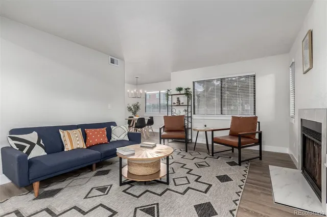 a living room with furniture a rug and a fireplace
