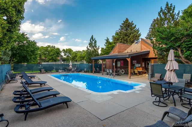 a view of a house with swimming pool and sitting area