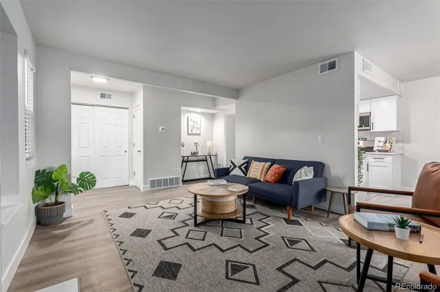 a living room with furniture and wooden floor