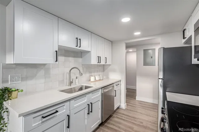 a kitchen with kitchen island granite countertop a sink stainless steel appliances and cabinets