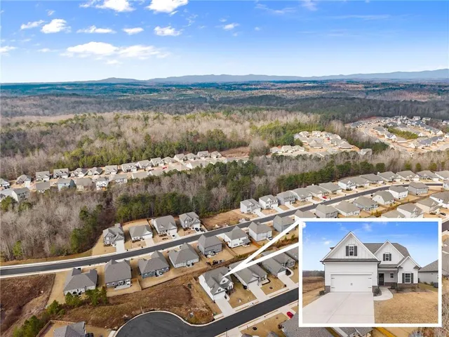 a view of a house with pool and a yard