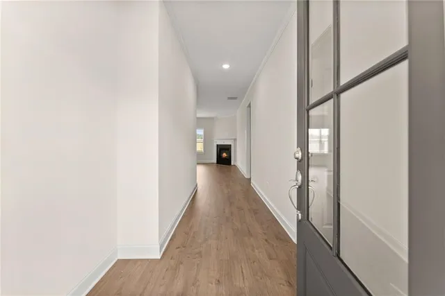a view of a hallway with wooden floor