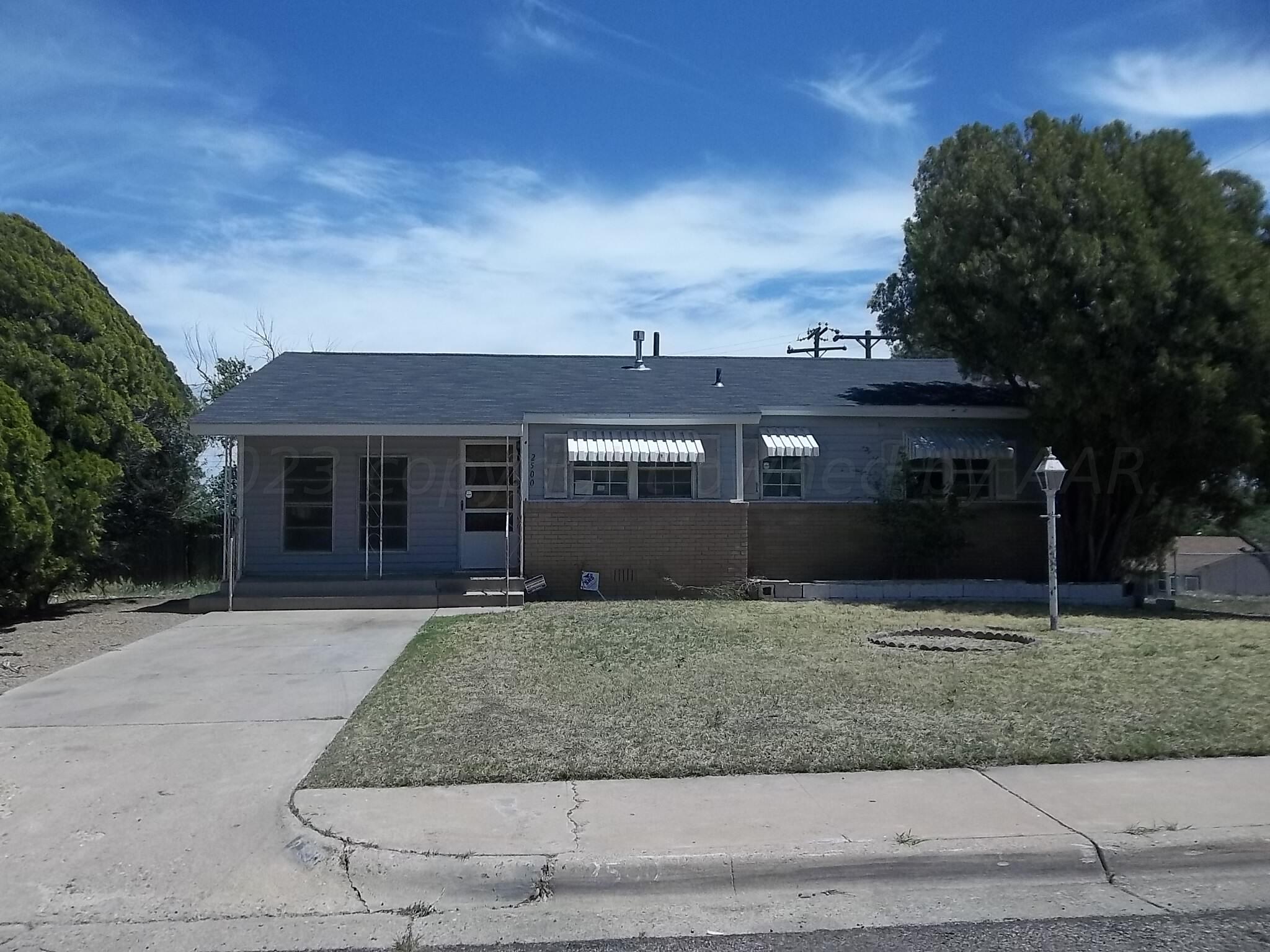 front view of a house with a yard