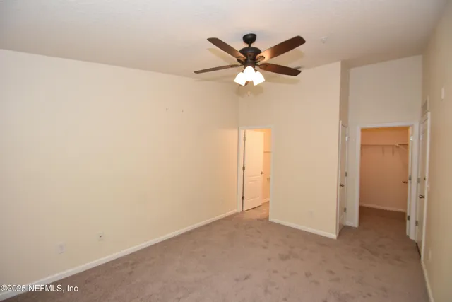 a view of a room with a fan and a fan
