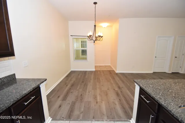 a view of a kitchen cabinets a sink and wooden floor