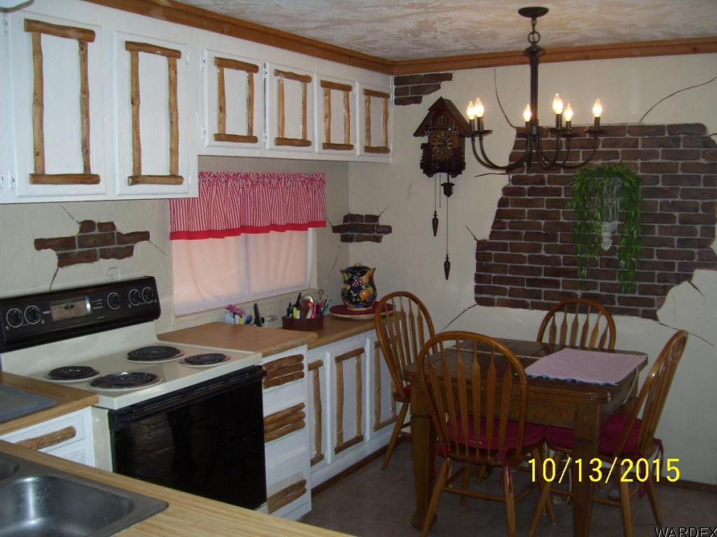 7185 Chocco Road Big River, CA 92242 - Photo 4 of 13 a kitchen with a stove a sink and chairs