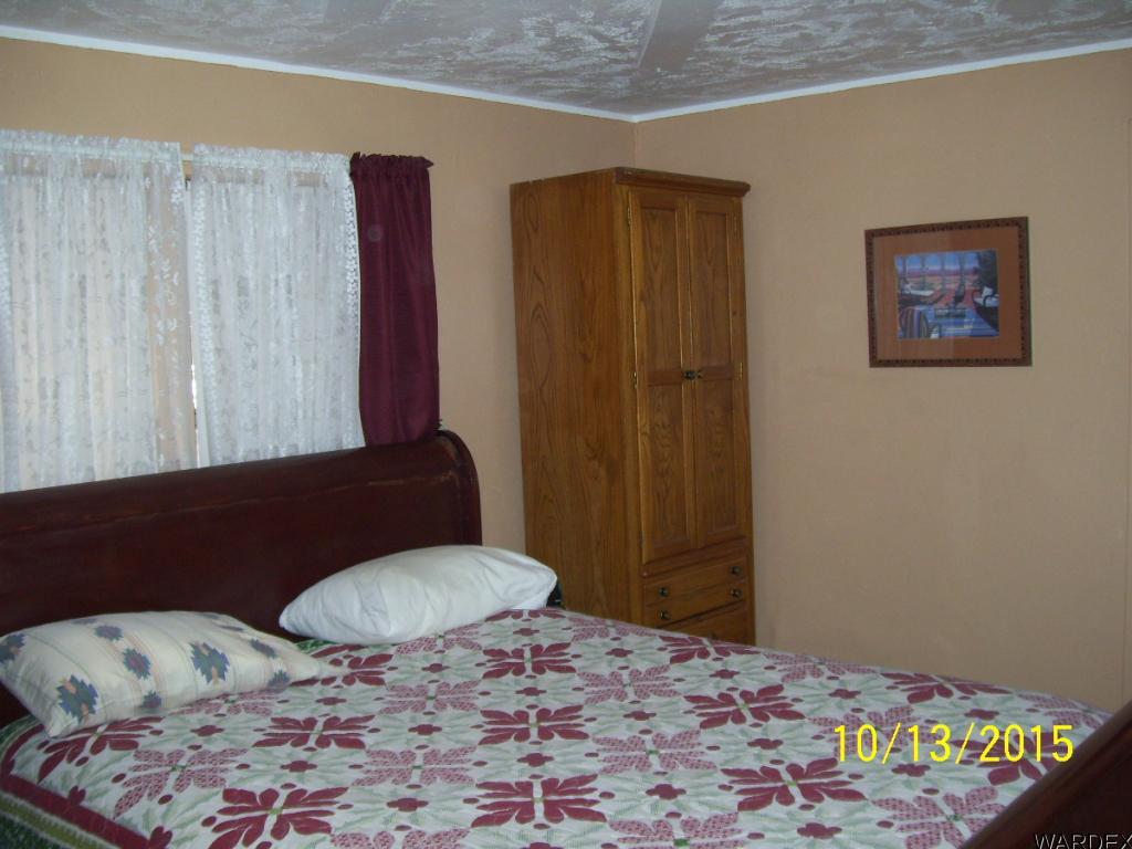 7185 Chocco Road Big River, CA 92242 - Photo 5 of 13 a bedroom with a bed and wooden floor