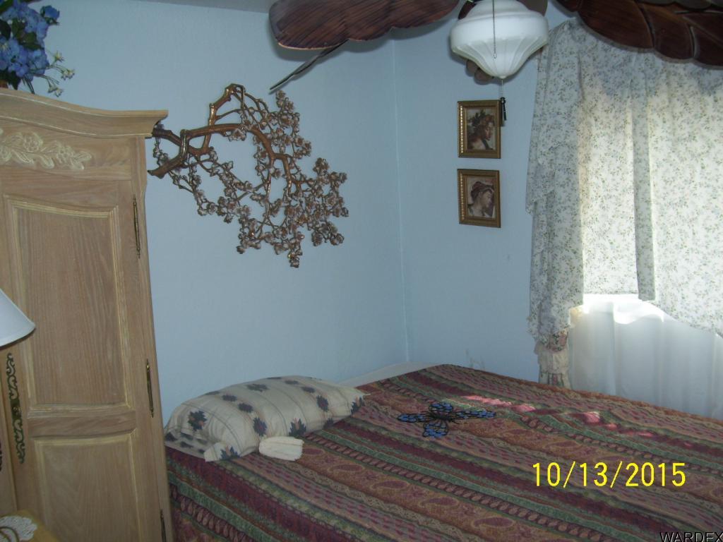 7185 Chocco Road Big River, CA 92242 - Photo 9 of 13 a bedroom with a bed and a window
