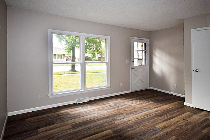 2008 Stanhope Road Springfield, IL 62702 - Photo 4 of 21 an empty room with wooden floor and windows