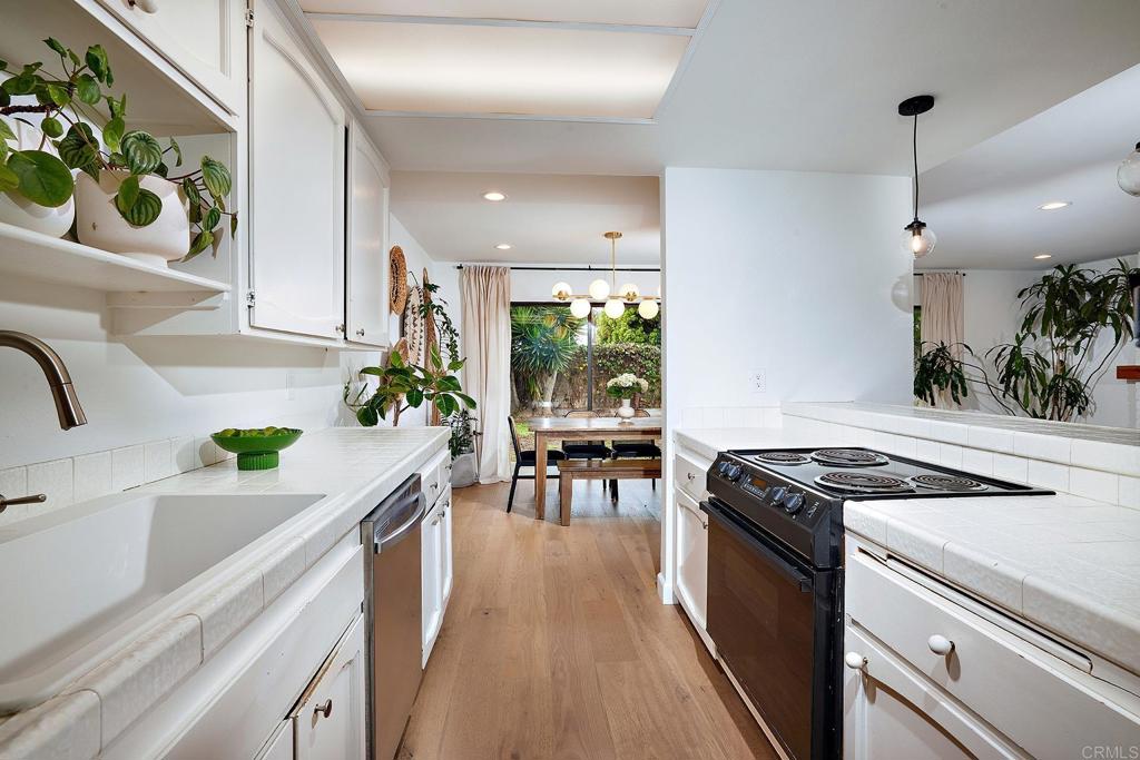 214 Calle De Madera Encinitas, CA 92024 - Photo 12 of 25 a kitchen that has a lot of cabinets in it