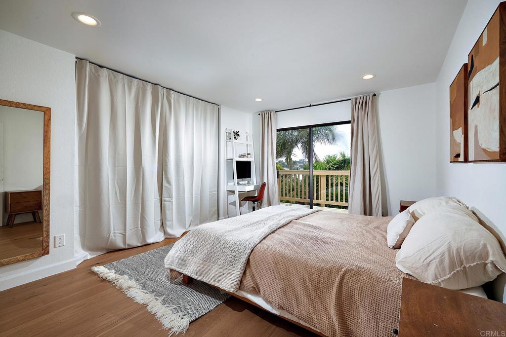 214 Calle De Madera Encinitas, CA 92024 - Photo 13 of 25 a bedroom with a large bed and a large window