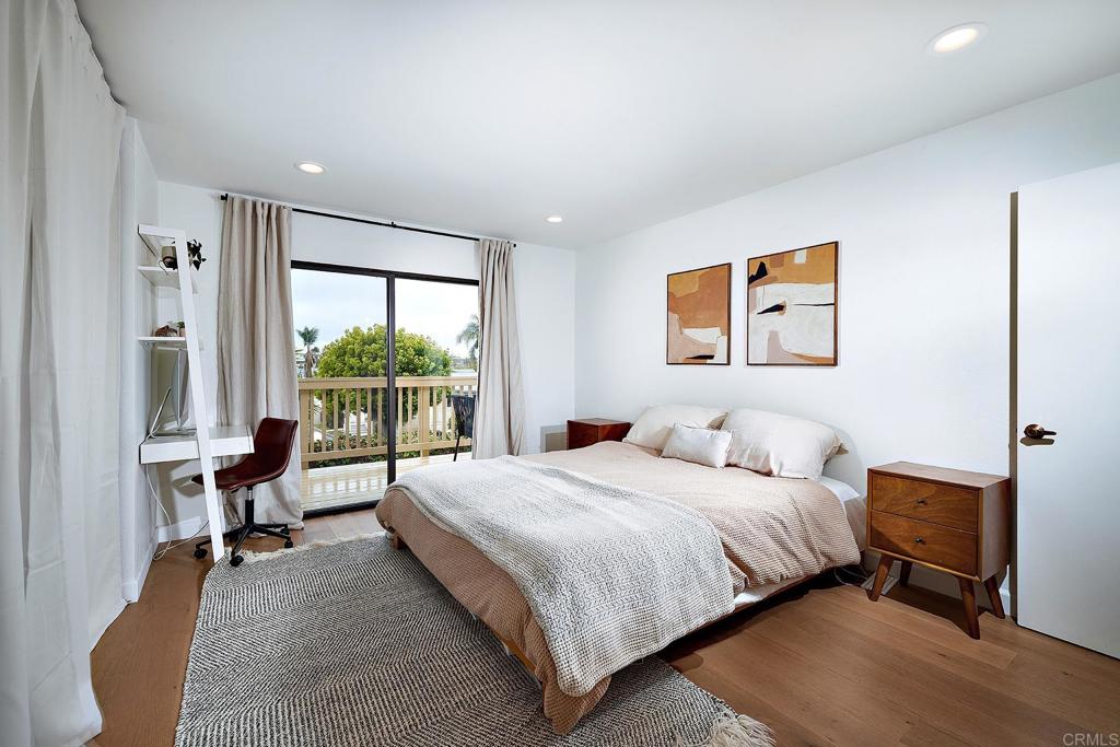 214 Calle De Madera Encinitas, CA 92024 - Photo 14 of 25 a bedroom with a bed and a large window