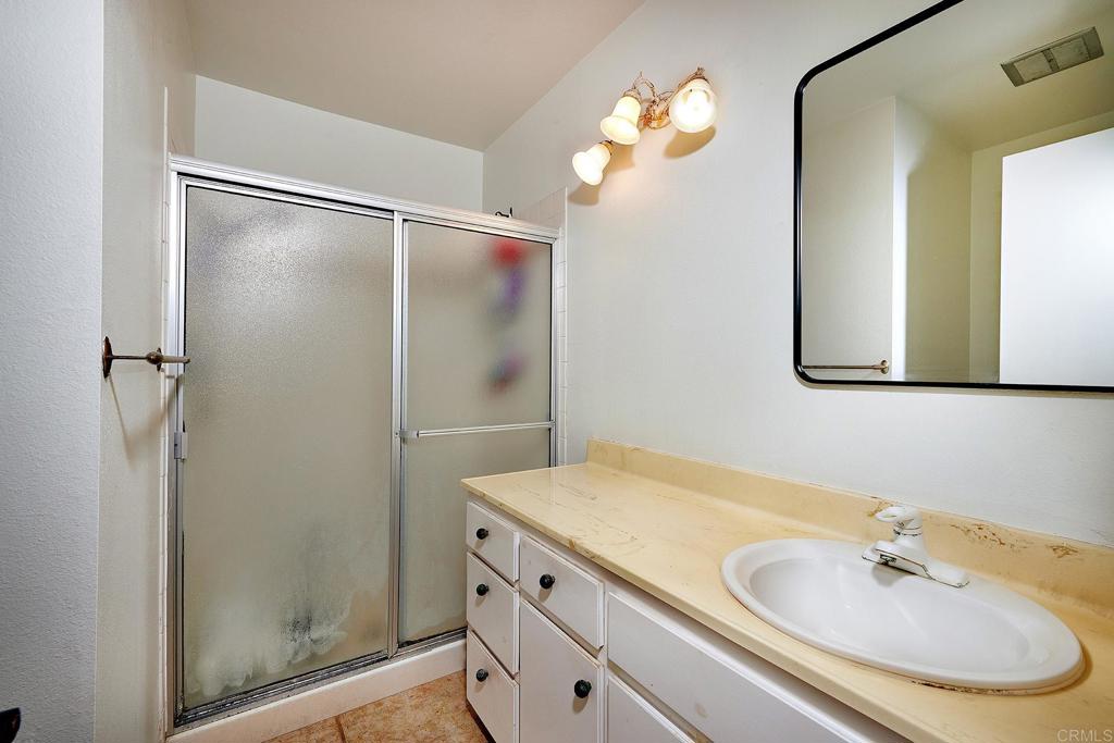 214 Calle De Madera Encinitas, CA 92024 - Photo 15 of 25 a bathroom with a sink and a mirror