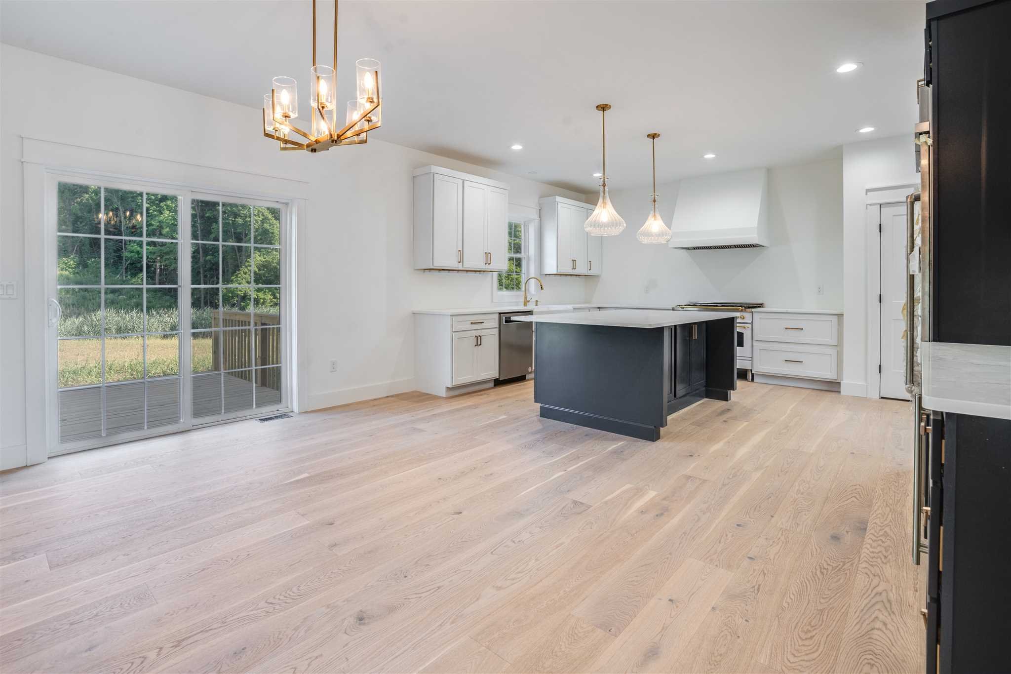 3 Cooper Road Fishkill, NY 12524 - Photo 4 of 26 a large kitchen with kitchen island a large counter space a sink appliances and cabinets