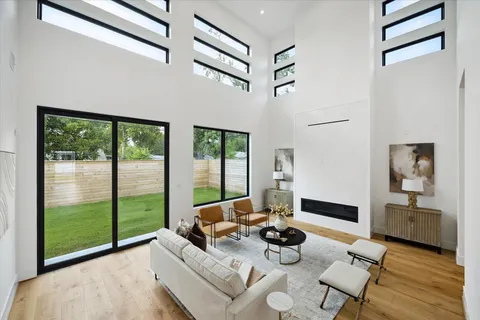 a living room with furniture and a floor to ceiling window