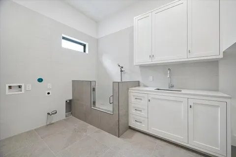 a kitchen with cabinets appliances a sink and a window