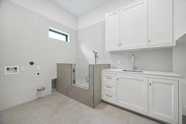 a kitchen with cabinets appliances a sink and a window