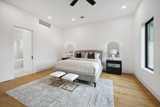 a bedroom with a bed and wooden floor