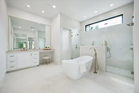 a large bathroom with a double vanity sink toilet and shower