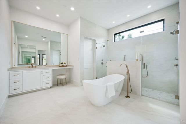 a large bathroom with a double vanity sink toilet and shower