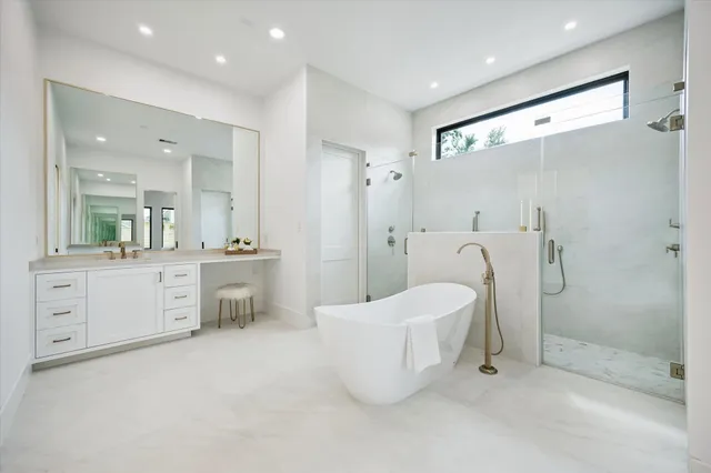 a large bathroom with a double vanity sink toilet and shower