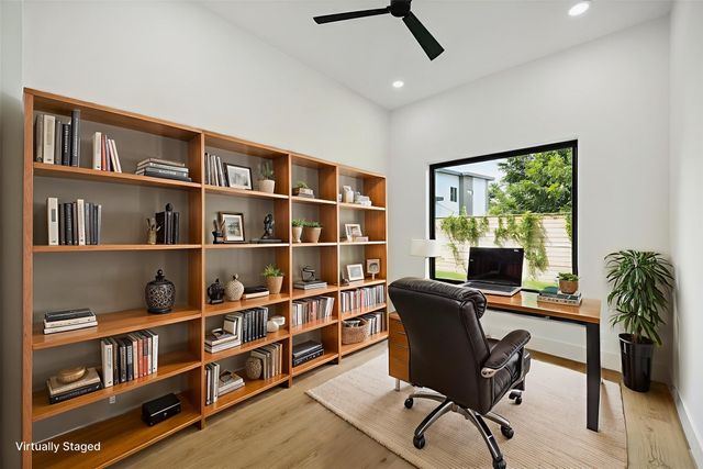a view of a workspace with furniture and a potted plant