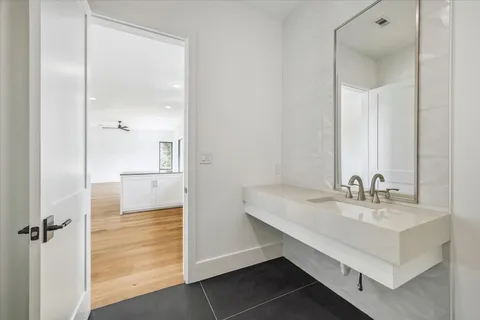 a bathroom with a sink a mirror and a shower