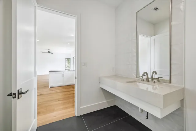 a bathroom with a sink a mirror and a shower