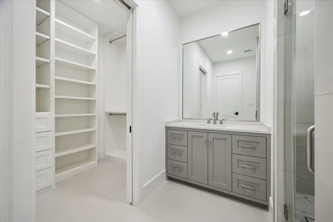 a bathroom with a bathtub shower sink vanity and toilet