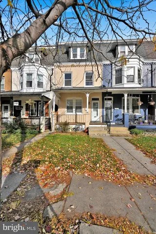 a front view of a building with a yard