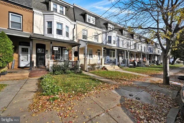 a front view of a building with a garden