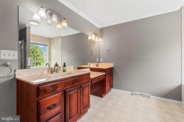 a view of an empty room with window and chandelier fan