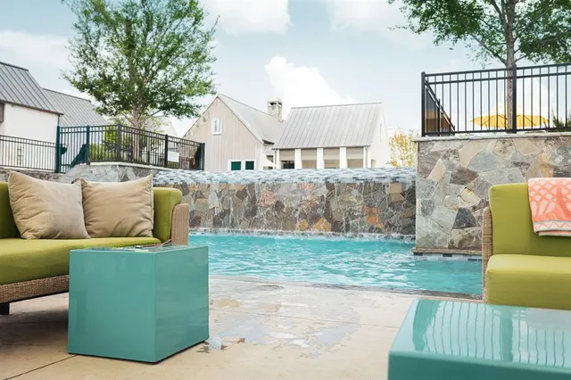 a view of a house with couches and a fire pit