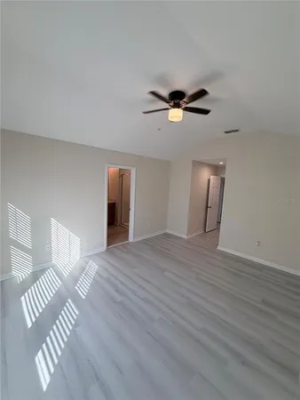 a view of a room with wooden floor and white walls
