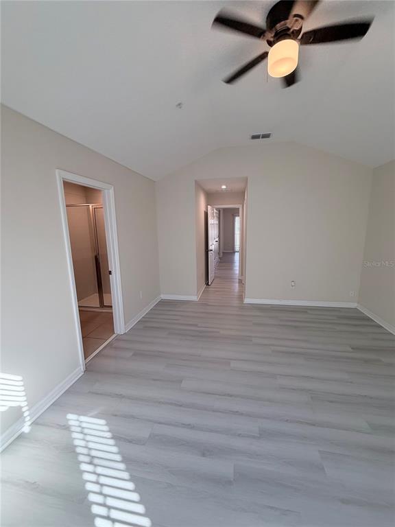 9463 Randal Park Boulevard Orlando, FL 32832 - Photo 18 of 25 a view of a room with wooden floor and white walls