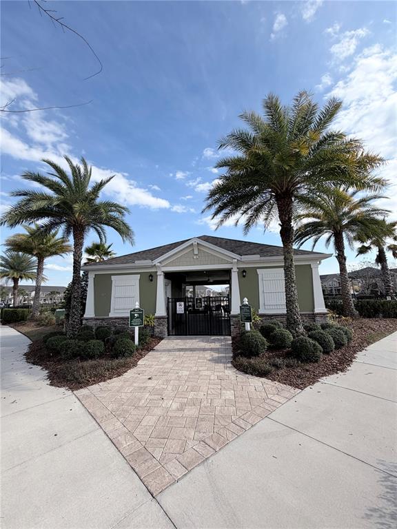 9463 Randal Park Boulevard Orlando, FL 32832 - Photo 23 of 25 a front view of a house with garden and trees