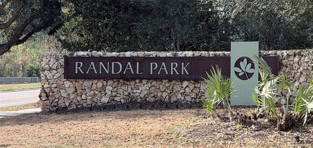9463 Randal Park Boulevard Orlando, FL 32832 - Photo 3 of 25 a street sign that is on a brick wall