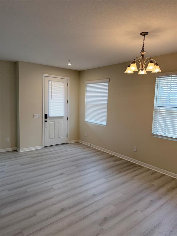 9463 Randal Park Boulevard Orlando, FL 32832 - Photo 7 of 25 wooden floor in an empty room with a window