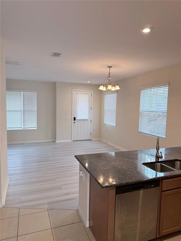 9463 Randal Park Boulevard Orlando, FL 32832 - Photo 8 of 25 a kitchen with a sink cabinets and chandelier