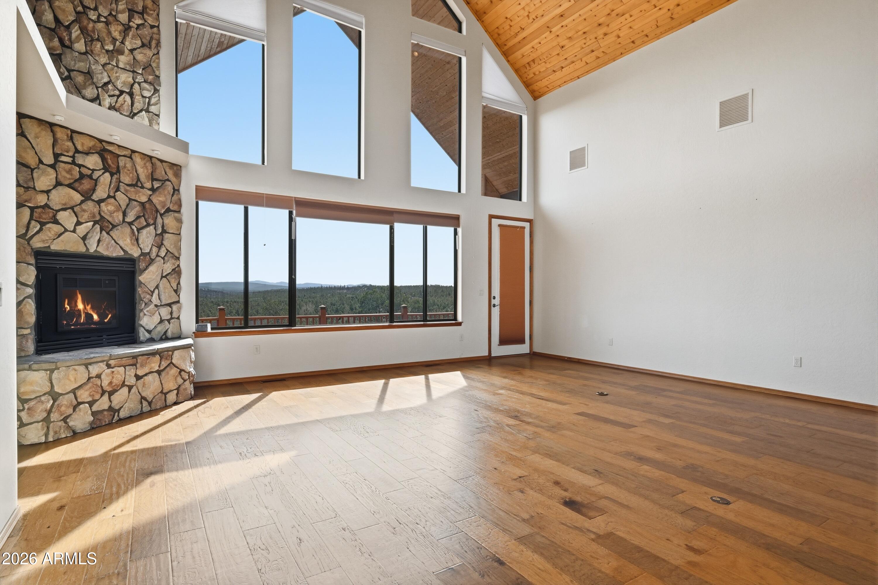 1561 South Canyon Ridge Trail Show Low, AZ 85901 - Photo 19 of 61 a view of an empty room with wooden floor and a fireplace