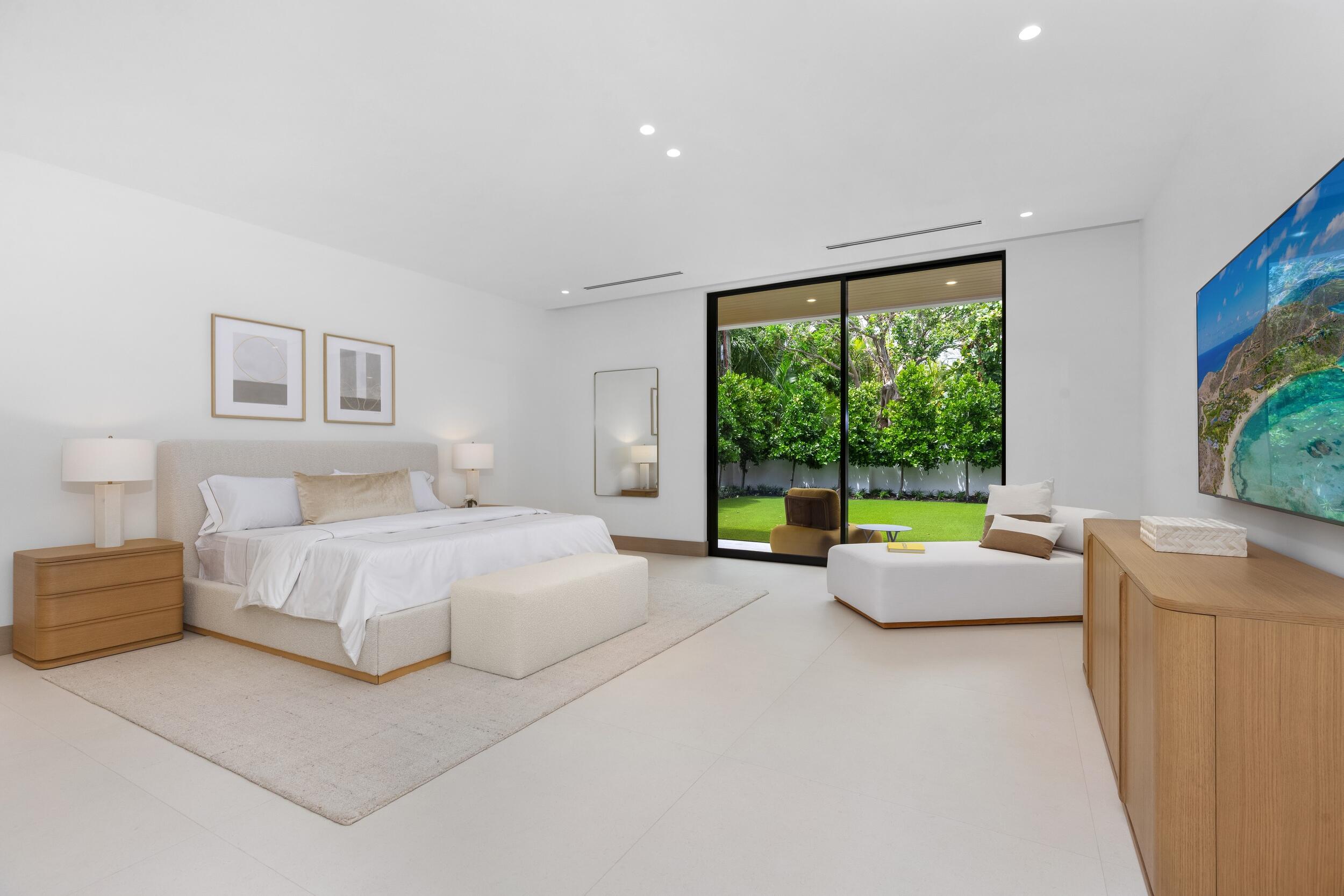 1351 Cocoanut Road Boca Raton, FL 33432 - Photo 81 of 101 a spacious bedroom with a large bed and a large window