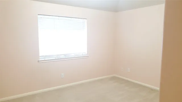 a view of an empty room and a window