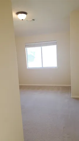 a view of a white house with a large tree and a yard