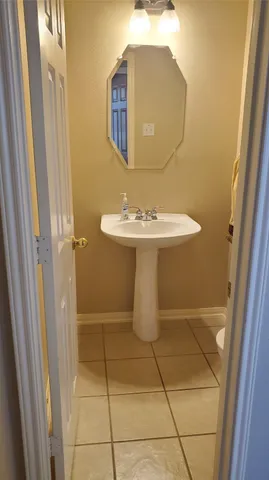 a view of a house with a yard and large trees