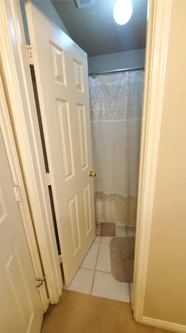 a bathroom with a granite countertop shower and a sink