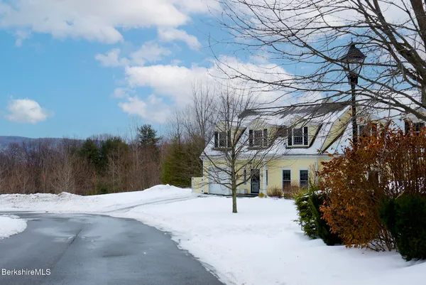 a view of house with a yard covered with snow