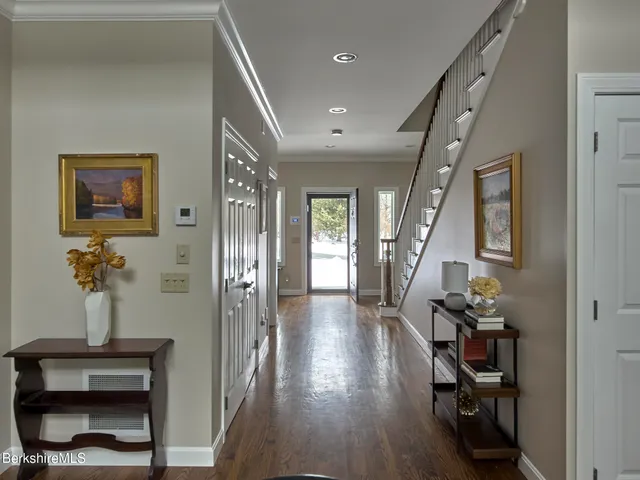 a view of a hallway with workspace and wooden floor