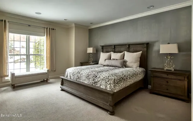 a bedroom with a bed and a lamp