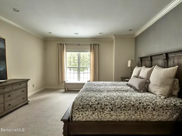 a bedroom with a large bed and a window